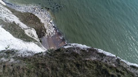 Aerial flight over The White Cliffs of Dover edge looking down they are cliffs that form part of the English coastline facing the Strait of Dover and France they are part of the North Downs formation