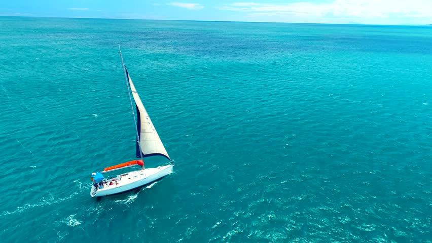 Yacht sailing on open sea at sunny day. Sailing boat in slow motion. Sailing aerial 4k video