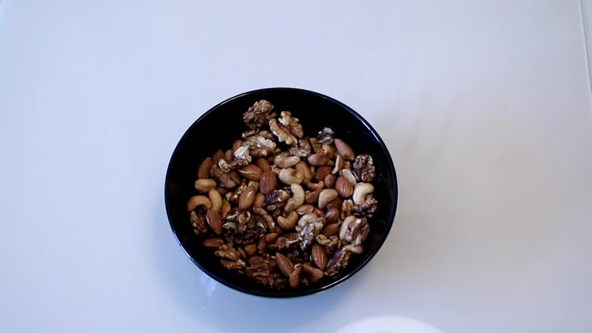 Nuts mix. Cashew. Walnut. Almond. Man hands take nuts. Assorted nuts