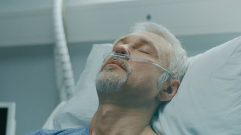 In the Hospital, Close-up Footage of Senior Patient Lying in Bed, Sleeping. Modern Hospital Geriatrics Ward. Shot on RED EPIC-W 8K Helium Cinema Camera.