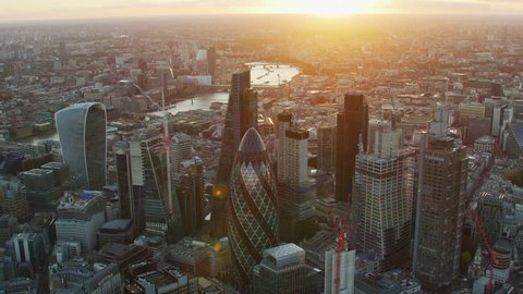 London UK - November 2017: Aerial view at sunset with sun flare London cityscape financial district modern skyscrapers Gherkin Cheesegrater England United Kingdom RED WEAPON