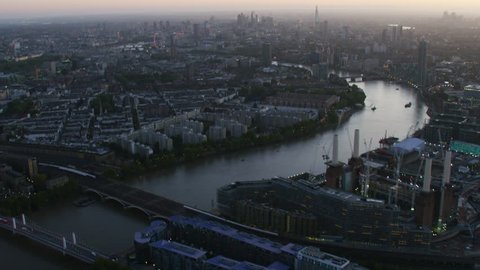Aerial view Battersea Power Station at sunrise Pimlico residential district River Thames and London city skyline England UK RED WEAPON Video Stok