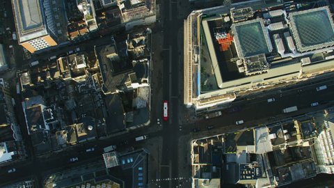 Aerial overhead view sunrise over Oxford Street commercial and retail rooftops public transport commuter vehicles London England UK RED WEAPON