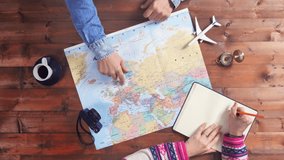 couple planning travel vacation on world map top view - Powered by Shutterstock - Get 15% off with code: PIKWIZARD15
