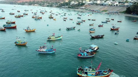 Top view. Aerial view fishing harbour market from drone. Royalty high quality free stock footage 4K of market at Mui Ne fishing harbour, fishing village. Fishing harbor is popular tourist destination