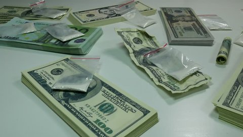 US dollar notes at 100, cocaine and drugs are on the table in modern American banks more criminal Finance Corporation.