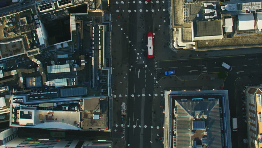 Aerial overhead view Oxford Street at sunrise commercial and retail building rooftops pedestrians commuter vehicles London England UK RED WEAPON