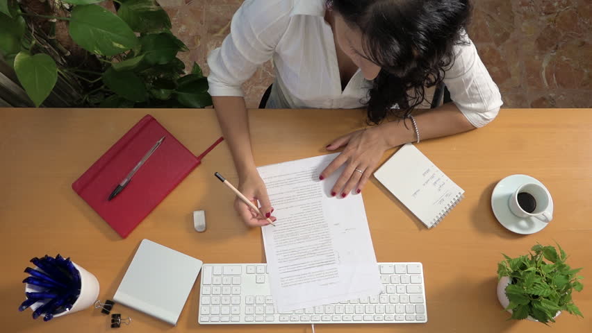 Businesswoman proofreading errors and omissions at office. Active caucasian woman reading draft text and deleting wrong content. Script revision of manager, company director correcting report Royalty-Free Stock Footage #1009772753