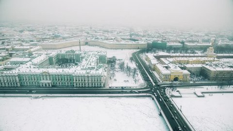 Aerial view of the panorama of the city of St. Petersburg, Russia, in winter, white snow, a frozen river, architecture in the fog, ice, roads, bridges.