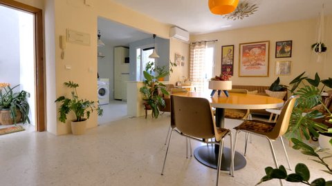 Malaga, Spain.Circa March 2018. Real estate virtual tour. Camera fly-through the interior of a retro decorated home. Vintage living room and kitchen.