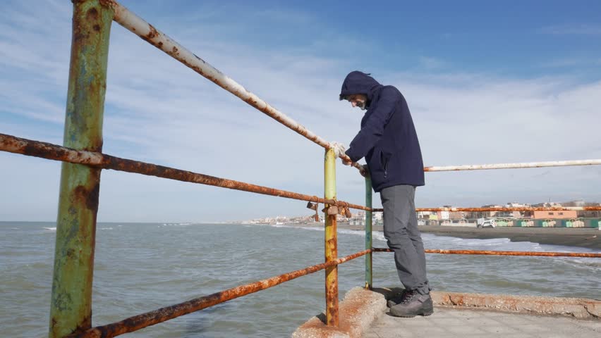 Mature man and the sea on a sunny windy day