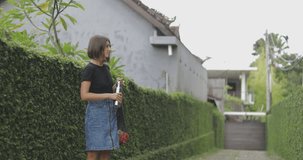 Young woman holds string shopping bag . Girl drinks water from reuseble metal bottle. Zero waste noplastic concept. 4k video shooting by handheld gimbal