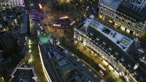 London UK - November 2017: Aerial rooftop view at night illuminated streets and buildings Piccadilly Circus pedestrians vehicle traffic London England United Kingdom RED WEAPON