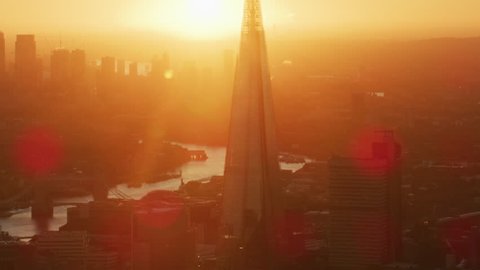 London UK - November 2017: Aerial sunrise view with sun flare London cityscape The Shard Tower Bridge River Thames Canary Wharf England UK RED WEAPON