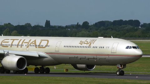 DUSSELDORF, GERMANY - JULY 23, 2017: Slow motion of Airbus A340 A6-EHI of Etihad Airlines (Abu Dhabi grand prix on livery) ride on taxiway after arrived. Dusseldorf International airport.