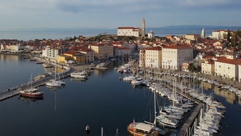 Aerial panorama of marina and old town Piran, with reflection at the sea, Slovenia