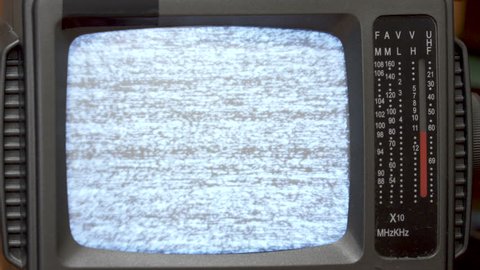 Closeup, Turn on and turn off Old Retro Portable TV  Television. White noise on Black and White  Crt