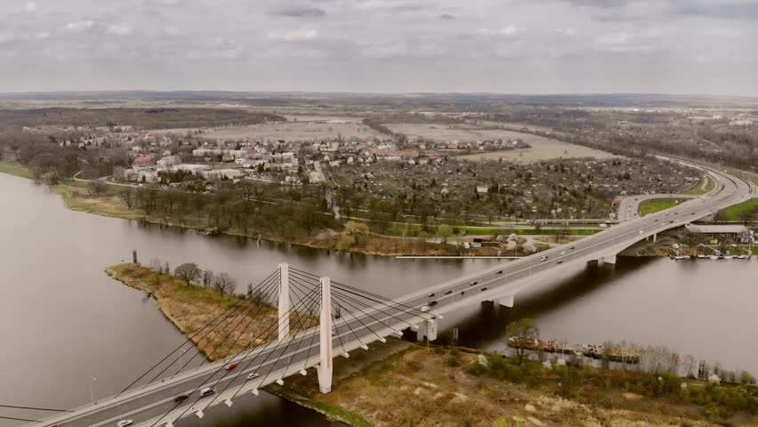 Milenijny Bridge in Wroclaw, Poland. Odra river, transport, cars, traffic / 4K Drone Video