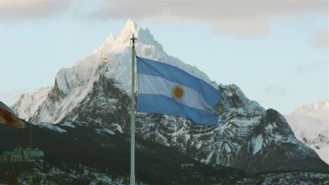 Argentinian Flag and the Mount Olivia at Sunset, in Ushuaia, Capital of Tierra del Fuego province, Argentina. 