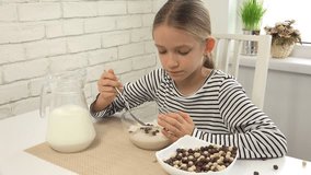 Child Eating Milk And Cereals at Breakfast in Kitchen, Girl Tasting Meal 4K