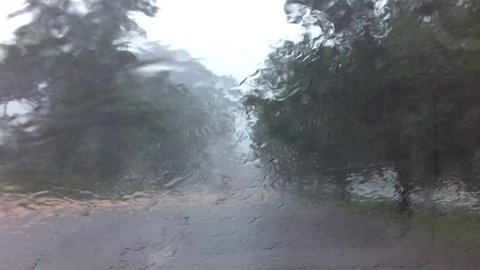 Driving car through heavy rain 