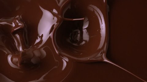 Chocolate falling in chocolate sauce. Slow motion.