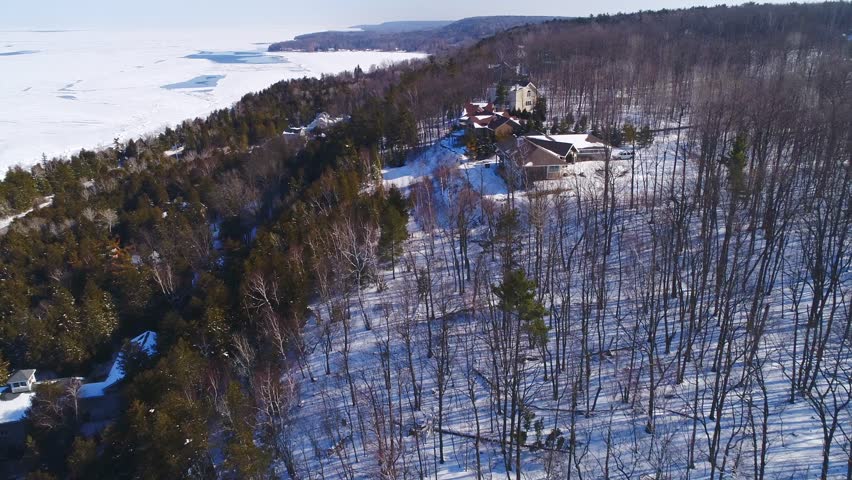 Aerial flyover of scenic hilltop homes in Winter, Door County, Wisconsin.
