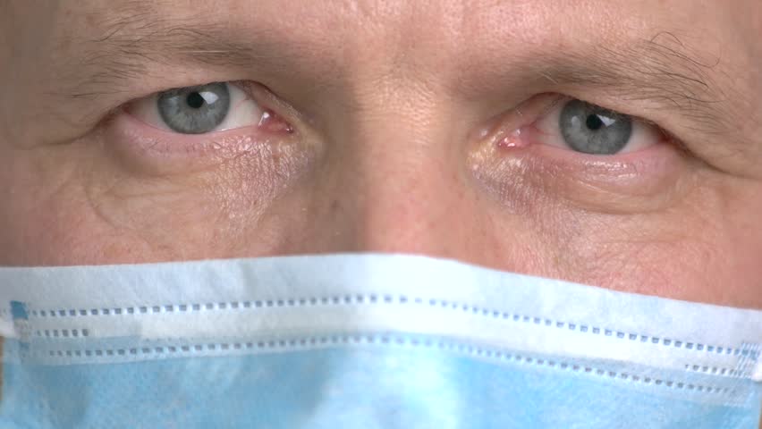 Close up doctor closing eyes. Serious mature doctor's eyes with wrinkles shut up.