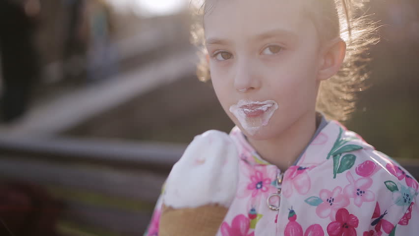 little girl eats licks ice cream: stockowe wideo (w 100% bez