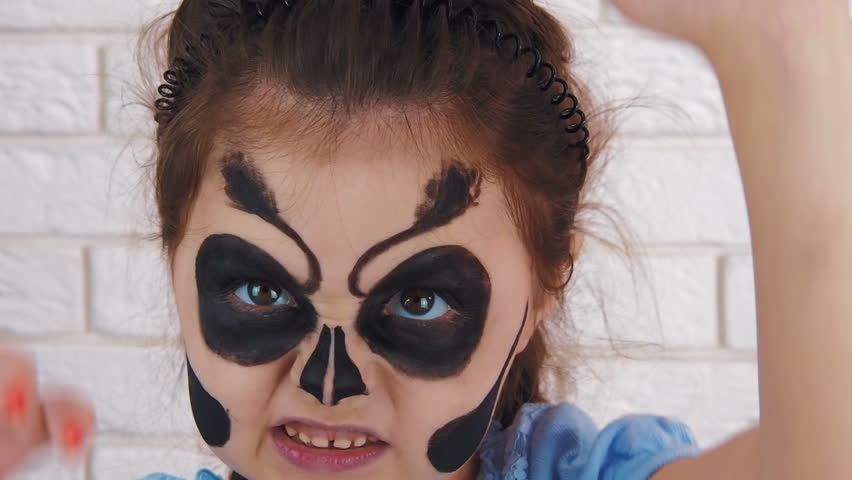 The painted face. Child Halloween. A terrible child.