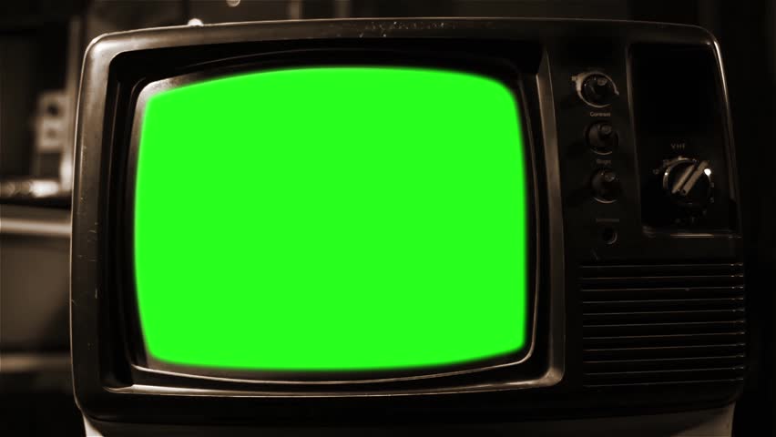 A Retro Television with Green Screen. Aesthetics of the 70s or 80s. Sepia Tone. Zoom In. You can replace green screen with the footage or picture you want. You can do it with “Keying” effect in AE. Royalty-Free Stock Footage #1009816547