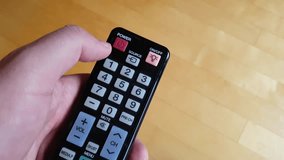 TV remote control. Royalty free video. Pushing the power button. 4K and HD footage.