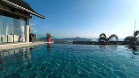 The young man is jumping into the pool with beautiful view - Powered by Shutterstock - Get 15% off with code: PIKWIZARD15