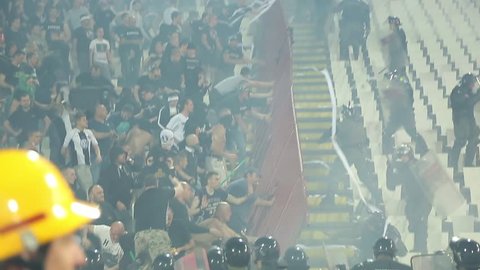 SERBIA, BELGRADE - April 15, 2018: Football fans during eternal rivals have met in the Eternal soccer derby, FC Partizan and Red Star from Belgrade, Conflict between the hooligans and police, 