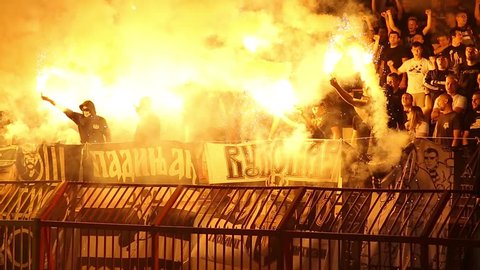 SERBIA, BELGRADE - April 15, 2018: Football fans during eternal rivals have met in the Eternal soccer derby, FC Partizan and Red Star from Belgrade, Conflict between the hooligans and police, 