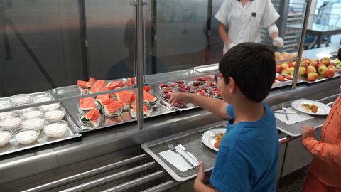 VIENNA AUSTRIA - CIRCA SEPTEMBER 2017: 2 boys at French high school getting food from from a school canteen