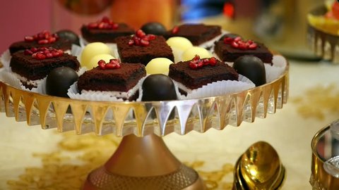 piece Chocolate cake decorated Pomegranate seeds and sweet candy in a beautiful bowl buffet table. food design slide movement concept celebration