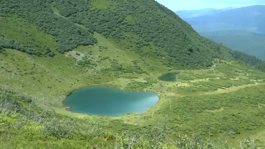Picturesque mountain landscape: a lake near the mountainside.