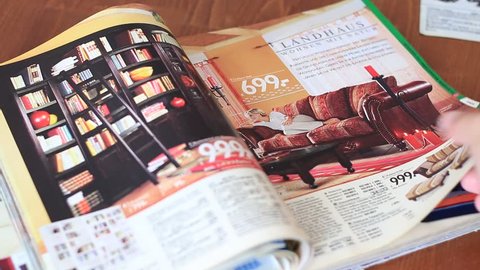 MOSCOW, RUSSIA, AUGUST 20, 2016: Flipping through the catalog of furniture for home "Otto".
