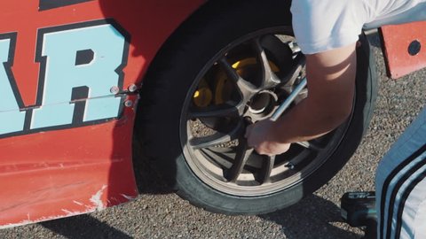 Mechanics change the wheel on a racing car