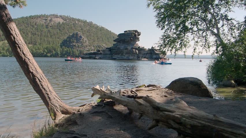 Families enjoying leisure water sports on Lake Borovoe in Kazakhstan