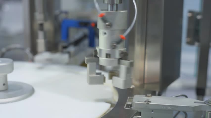 Imitation of the capping machine. Pharmaceutical industrial equipment.
