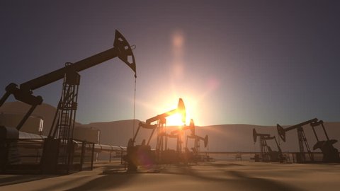 Sunrise over oil field with oil pump jacks and oil pipeline