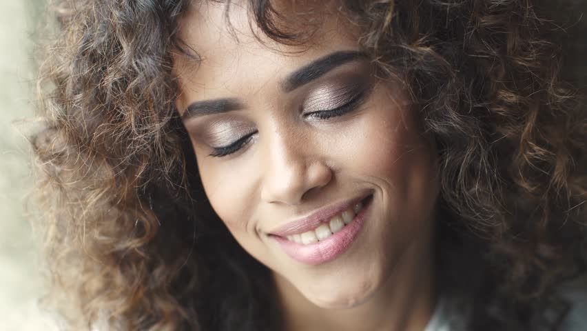 Close-up portrait of a curly girl. beautiful make-up and hairstyle. headshot portrait of a attractive hispanic girl with a beautiful smile | Shutterstock HD Video #1009852592