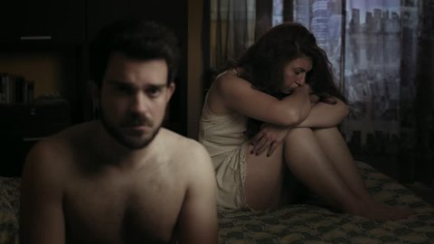 male sexual impotence: young sad couple in bed