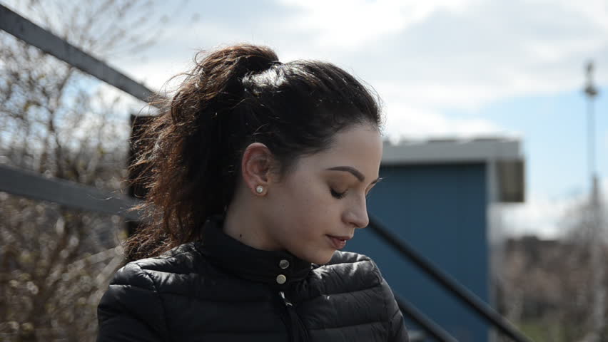 Young Woman Putting on Glasses