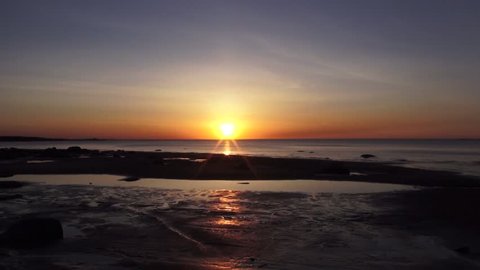 Sunset on the shore of the Gulf of Finland. Time lapse video full hd.