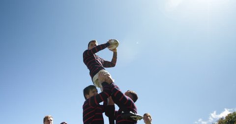 Rugby players practicing to defend the ball on a sunny day 4K 4k