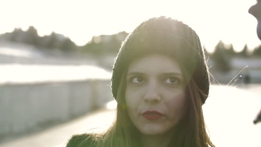 Beautiful young woman talking at the sunset
