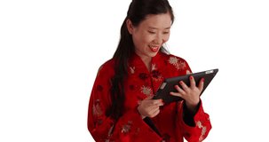 Happy young female tourist using tablet device for copy space. Close up of millennial woman smiling and reading a portable tablet computer isolated on white backdrop. 4k